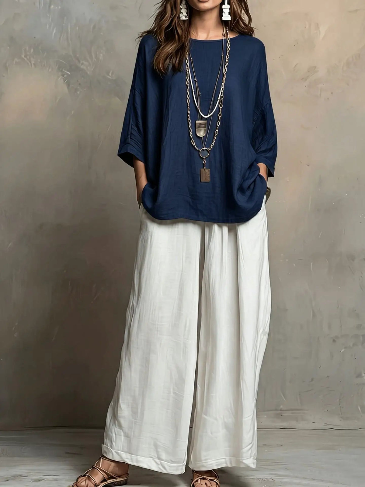 Bohemian style loose women’s outfit set: navy top with white wide-leg pants and layered necklaces