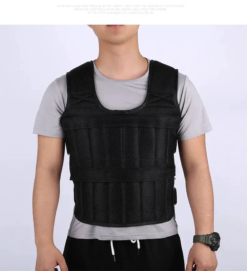 Black weight vest with mesh panels and adjustable straps worn by a man over a gray T-shirt
