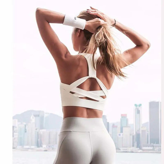 White push-up sports bra with hollow-out back and crisscross straps for gym, yoga and running