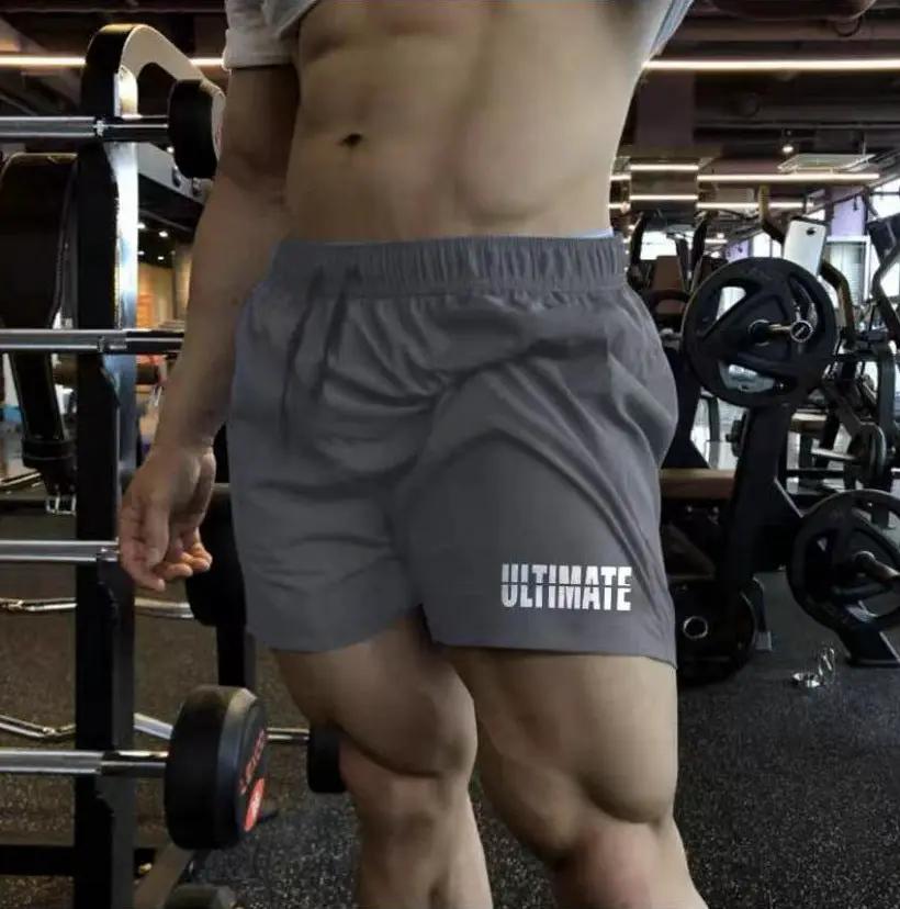 Men's gray quick-dry gym shorts with elastic waistband and Ultimate logo