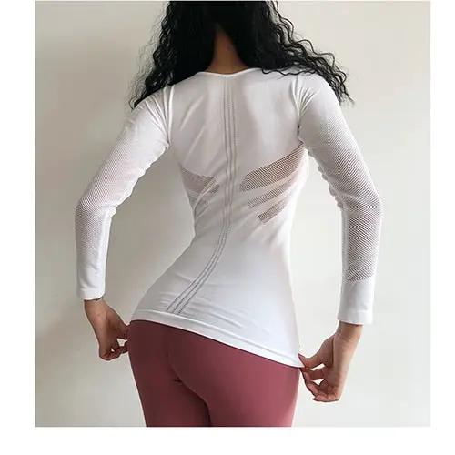 Women's white long-sleeve fitness top with side mesh panels, fitted gym/yoga shirt