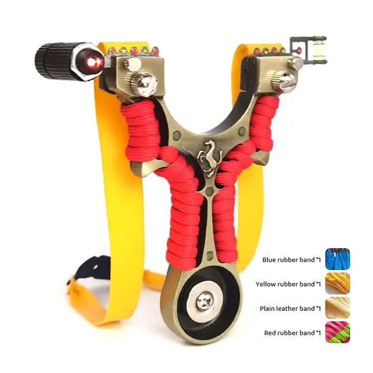 Metal flat-skin slingshot with yellow frame and red paracord wraps; laser infrared sight on each arm