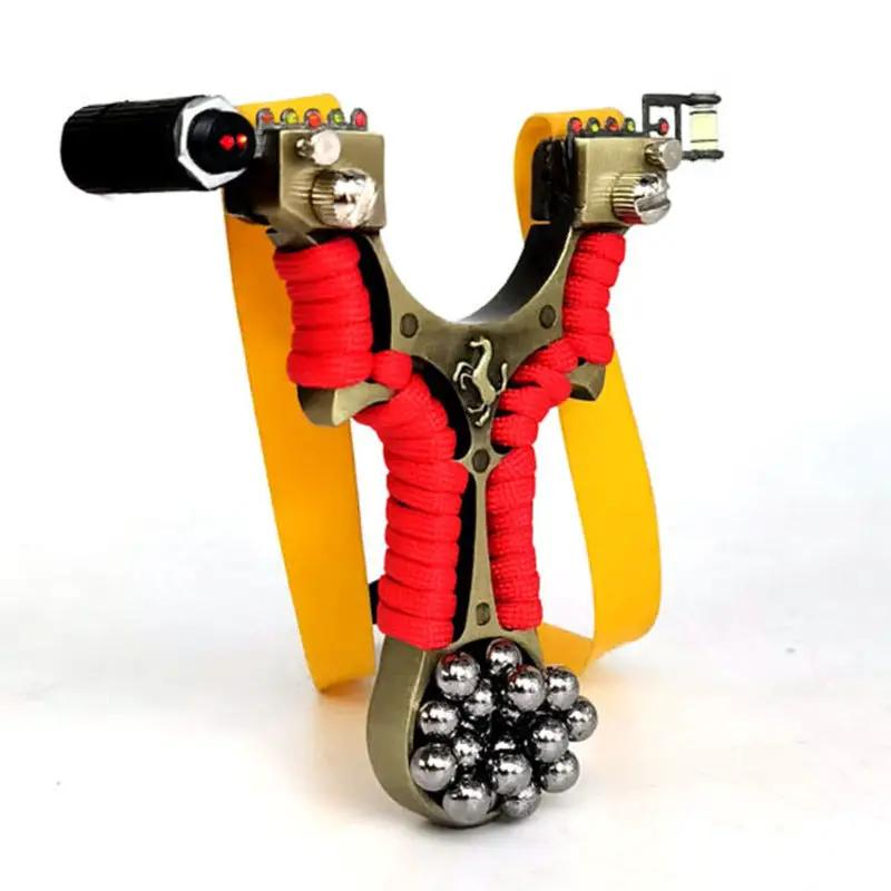 Metal flat slingshot with yellow fork and red-wrapped arms, built-in laser sight, and steel ammo balls