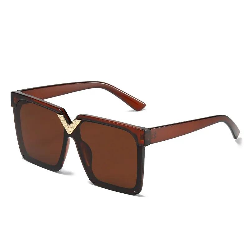 Sunglasses square V-shaped oversized frame with brown lenses and translucent brown temples.