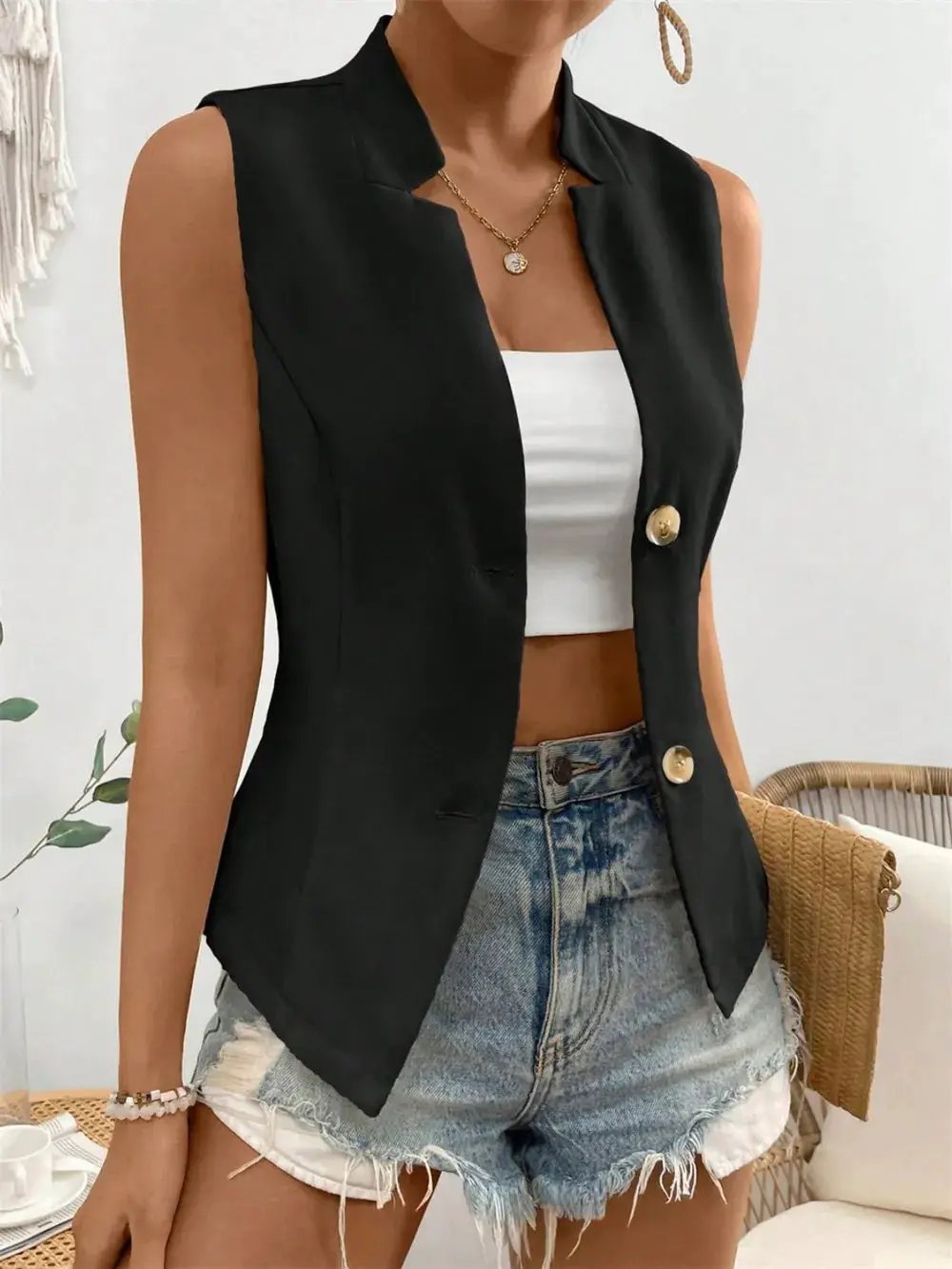 Button Down Vest Coat in black with gold buttons, worn over a white crop top and denim shorts