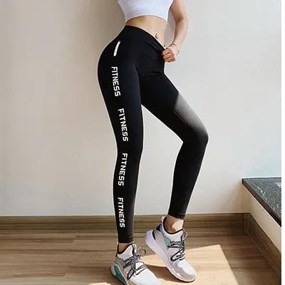 Women's black fitness leggings with white FITNESS text along the legs