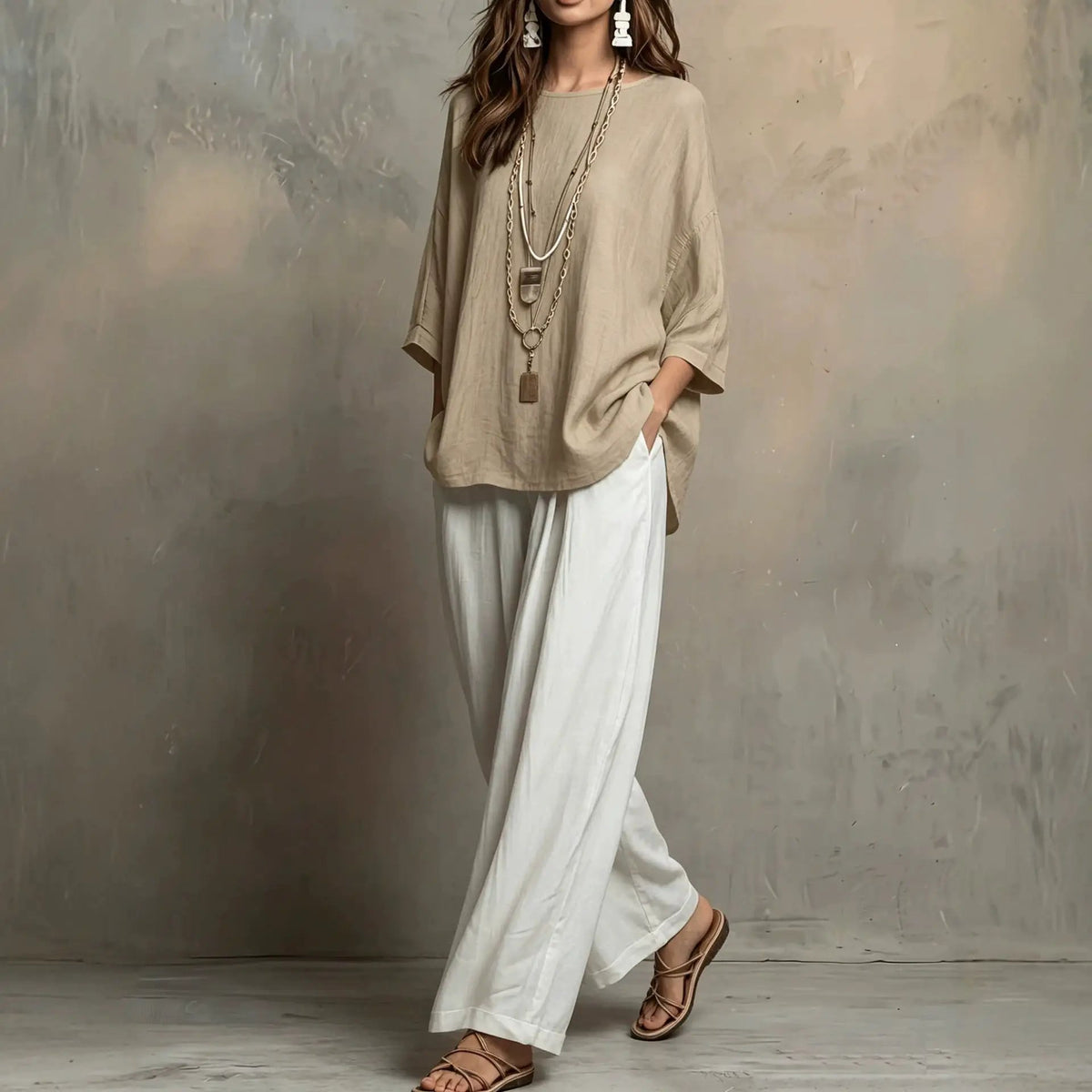 2-piece Bohemian-style loose tunic and pants set in beige and white, styled with layered necklaces and sandals.