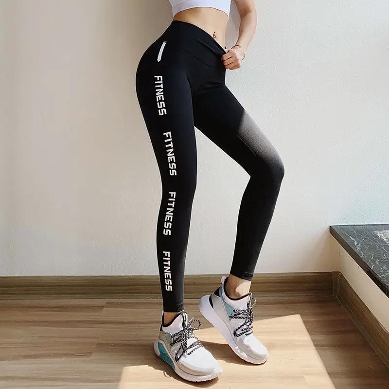 Fitness leggings for women, black high-waist 4-way stretch with FITNESS text along leg